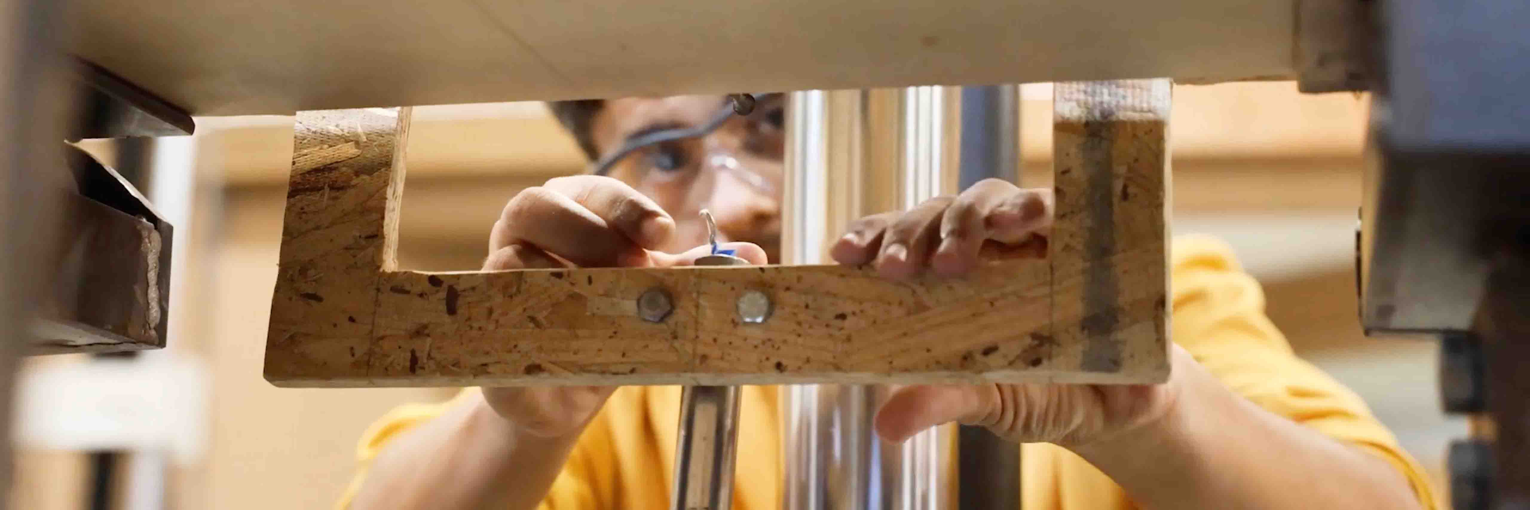 A student researcher places CLT into a stress testing machine