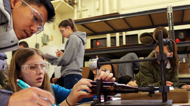 Virginia Tech sustainable biomaterials students taking measurements of a bottle.