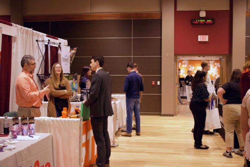 Hokie Pack Job Fair Students talking to employers standing in booths at a job fair